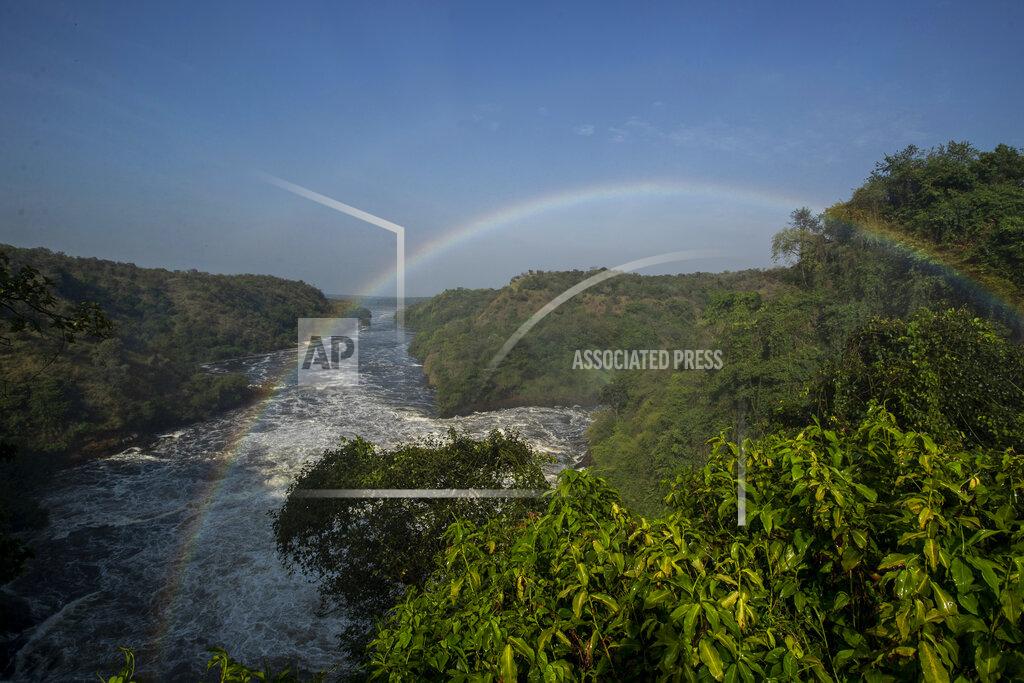 Uncredited A rainbow forms in the mist at the top of the waterfalls in Murchison Falls National Park, northwest Uganda, on Feb. 22, 2020. The East Africa Crude Oil Pipeline, a controversial oil project that would connect oilfields in the park to a port in Tanzania is in breach of global environmental and human rights guidelines for banks, according to a new report by Inclusive Development International on Tuesday, July 5. (AP Photo)