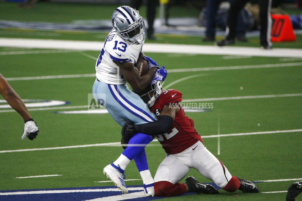 Michael Ainsworth Dallas Cowboys wide receiver Michael Gallup (13) catches a pass for a first down as Arizona Cardinals safety Budda Baker (32) makes the stop in the first half of an NFL football game in Arlington, Texas, Monday, Oct. 19, 2020. (AP Photo/Michael Ainsworth)