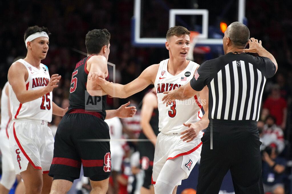Rick Scuteri An NCAA official breaks up a scuffle between Stanford guard Michael O'Connell (5) and Arizona guard Pelle Larsson (3) during the first half of an NCAA college basketball game Thursday, March 3, 2022, in Tucson, Ariz. (AP Photo/Rick Scuteri)
