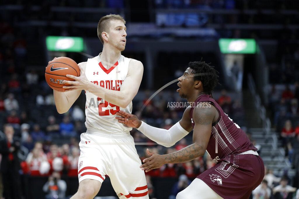 Jeff Roberson Bradley's Nate Kennell, left, looks to pass around Southern Illinois' Lance Jones during the first half of an NCAA college basketball game in the quarterfinal round of the Missouri Valley Conference men's tournament Friday, March 6, 2020, in St. Louis. (AP Photo/Jeff Roberson)