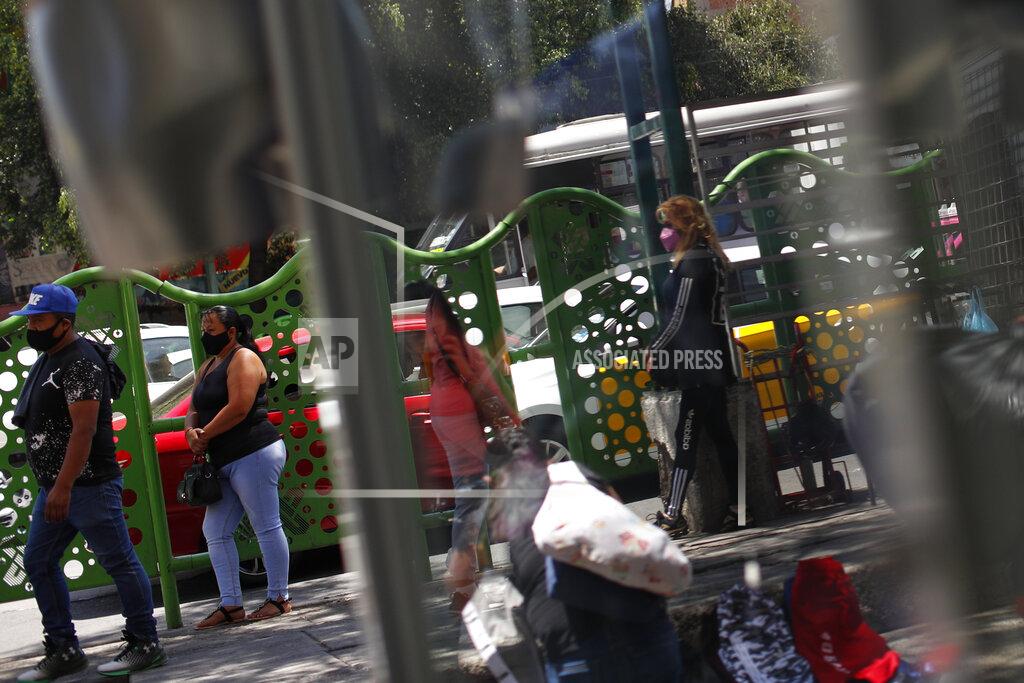 Rebecca Blackwell Claudia, second left, who had stopped working the streets a decade after marrying one of her former clients, waits for clients on a street in central Mexico City, Thursday, March 25, 2021. "It is hard to come back and see so many of my fellow workers from the old days, my era, going back to do the same thing ... to see all the problems out there," said Claudia who had fallen four months behind on rent after her husband lost his job early in the pandemic. (AP Photo/Rebecca Blackwell)