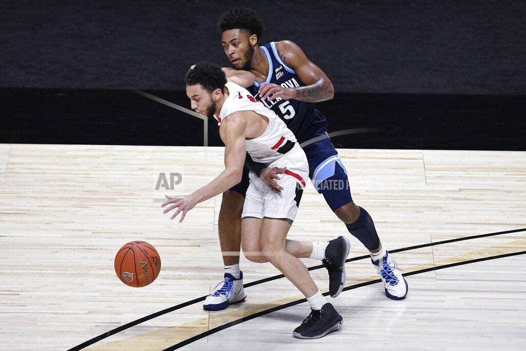 Jessica Hill Hartford's D.J. Mitchell dribbles the ball under pressure from Villanova's Justin Moore, right, in the first half of an NCAA college basketball game, Tuesday, Dec. 1, 2020, in Uncasville, Conn. (AP Photo/Jessica Hill)