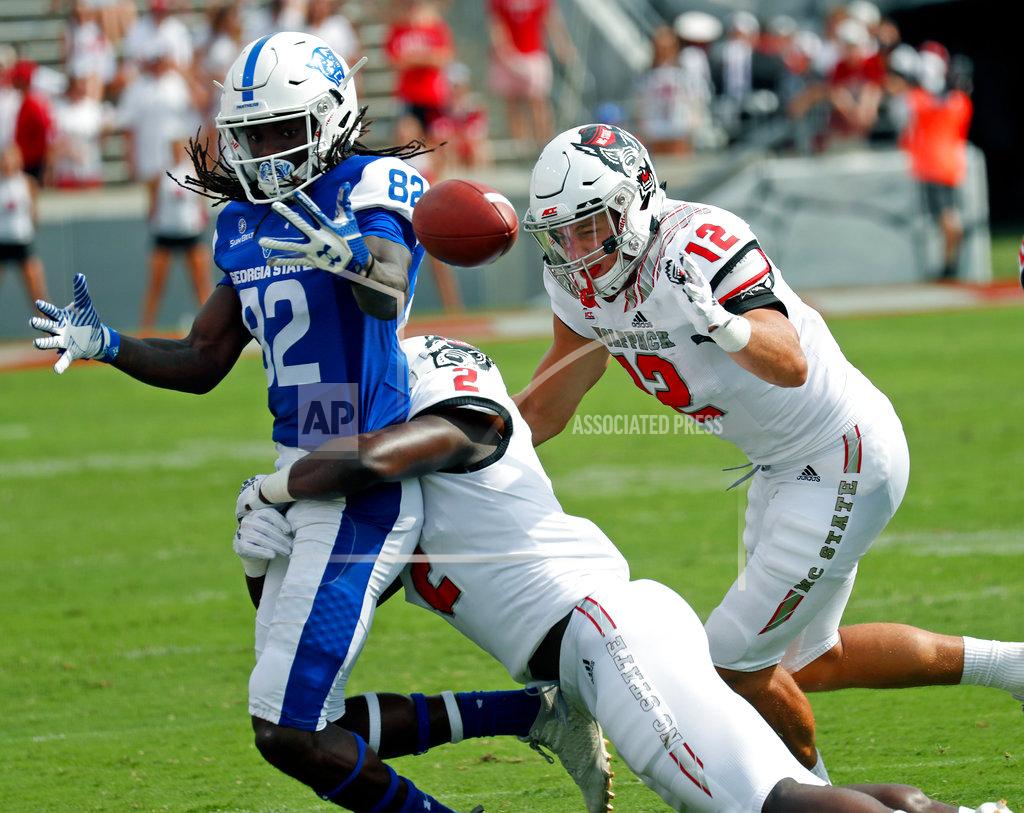 Chris Seward Georgia State's Diondre Champaigne (82) fumbles the ball as he is hit by North Carolina State's Louis Acceus (2) and Brock Miller (12) during the second half of an NCAA college football gam in Raleigh, N.C., Saturday, Sept. 8, 2018. (AP Photo/Chris Seward)
