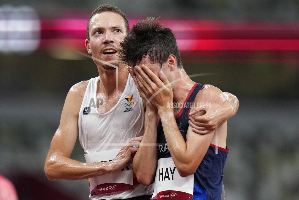 Petr David Josek Robin Hendrix, of Belgium, left, embraces Hugo Hay, of France, after their men's 5,000-meters at the 2020 Summer Olympics, Tuesday, Aug. 3, 2021, in Tokyo. (AP Photo/Petr David Josek)