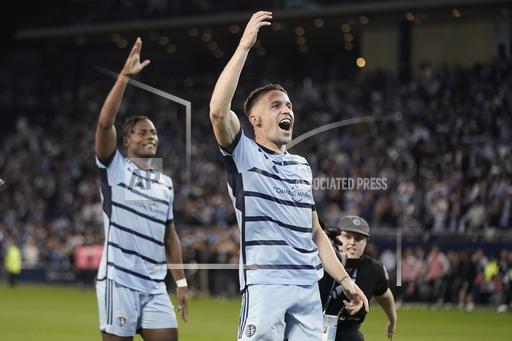 Sporting Kansas City defenders Dany Rosero, left, and Andreu Font&agrave;s celebrate after beating the San Jose Earthquakes in an MLS soccer wild-card playoff match Wednesday, Oct. 25, 2023, in Kansas City, Kan. Sporting Kansas City won in a penalty shootout to advance to the playoffs. (AP Photo/Charlie Riedel)