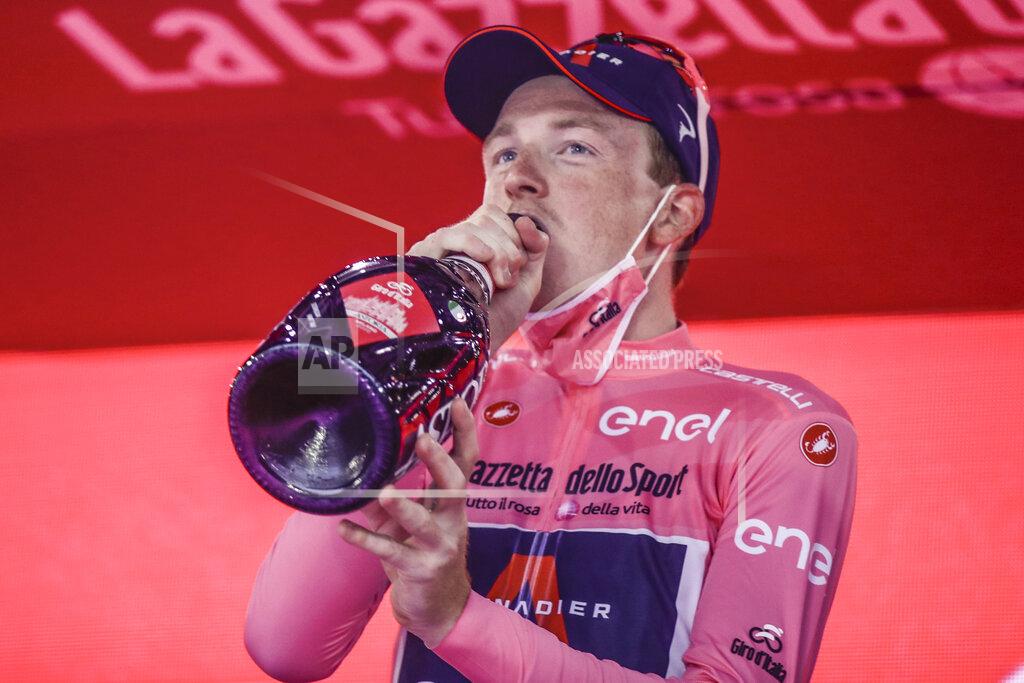 Luca Bruno Britain's Tao Geoghegan Hart celebrates on the podium after winning the Giro d'Italia cycling race, in Milan, Italy, Sunday, Oct. 25, 2020. (AP Photo/Luca Bruno)