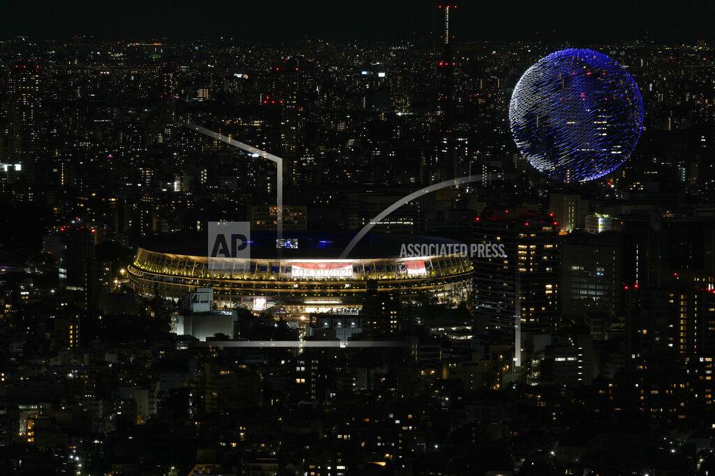 Eugene Hoshiko Drones fly over the National Stadium during the opening ceremony of 2020 Tokyo Olympics is seen from Shibuya Sky observation deck Friday, July 23, 2021, in Tokyo, Japan. (AP Photo/Eugene Hoshiko)