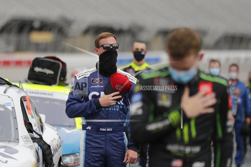 Brynn Anderson Ryan Sieg, left, stands during the national anthem in pit row before a NASCAR Xfinity Series auto race at Atlanta Motor Speedway, Saturday, June 6, 2020, in Hampton, Ga. (AP Photo/Brynn Anderson)