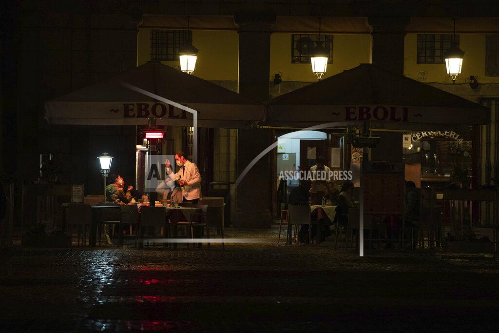 Manu Fernandez People sit in a terrace of a bar in downtown Madrid, Spain, Friday, Oct. 23, 2020. (AP Photo/Manu Fernandez)