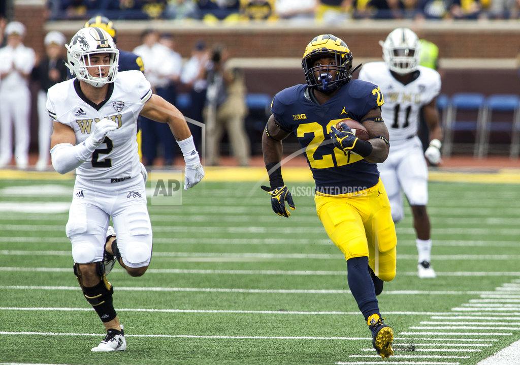 Tony Ding Michigan running back Karan Higdon (22) sprints away from Western Michigan defensive back Justin Tranquill (2) towards the end zone for a 67-yard touchdown run in the first quarter of an NCAA college football game in Ann Arbor, Mich., Saturday, Sept. 8, 2018. (AP Photo/Tony Ding)