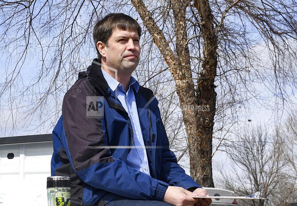 FILE - In this March 17, 2020 file photo, Dan Ahlers, a Democratic candidate for U.S. Senate, waits outside to encourage participation in drive-through petition signing, in Sioux Falls, S.D. (Erin Bormett/The Argus Leader via AP, File)