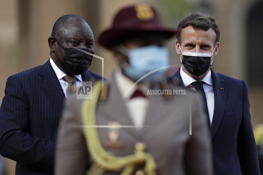 Themba Hadebe South African President Cyril Ramaphosa, left, and his French counterpart Emmanuel Macron walk during a welcoming ceremony at the government's Union Buildings, in Pretoria, South Africa, Friday, May 28, 2021. Macron is on a two-day official visit to the country. (AP Photo/Themba Hadebe, Pool)