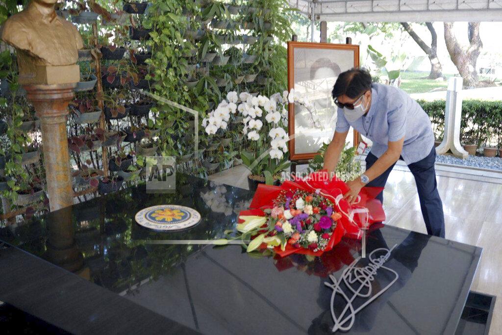 Uncredited In this photo provided by the Office of Ferdinand Marcos Jr., Presidential candidate Ferdinand "Bongbong" Marcos Jr. places flowers on top of the tomb of his father at the National Heroes Cemetery in Metro Manila, Philippines, on Tuesday May 10, 2022. Marcos, the namesake son of longtime dictator Ferdinand Marcos, apparent landslide victory in the Philippine presidential election is raising immediate concerns about a further erosion of democracy in Asia and could complicate American efforts to blunt growing Chinese influence and power in the Pacific.(Office of Ferdinand Marcos Jr. via AP)