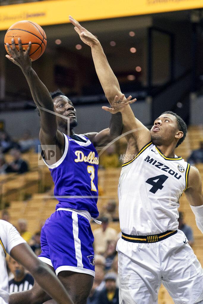 L.g. Patterson Paul Quinn's Ja'Mere Redus, left, shoots over Missouri's Javon Pickett, right, during the first half of an NCAA college basketball game Monday, Nov. 29, 2021, in Columbia, Mo. (AP Photo/L.G. Patterson)