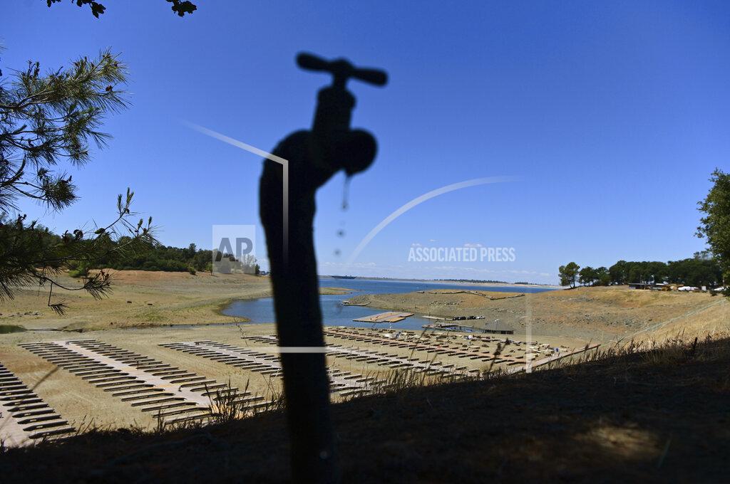 Josh Edelson FILE - In this May 22, 2021, file photo, water drips from a faucet near boat docks sitting on dry land at the Browns Ravine Cove area of drought-stricken Folsom Lake in Folsom, Calif. California Gov. Gavin Newsom threatened Monday, May 23, 2022, to impose mandatory, statewide restrictions on water use if people don't start using less on their own as the drought drags on and the hotter summer months approach. (AP Photo/Josh Edelson, File)