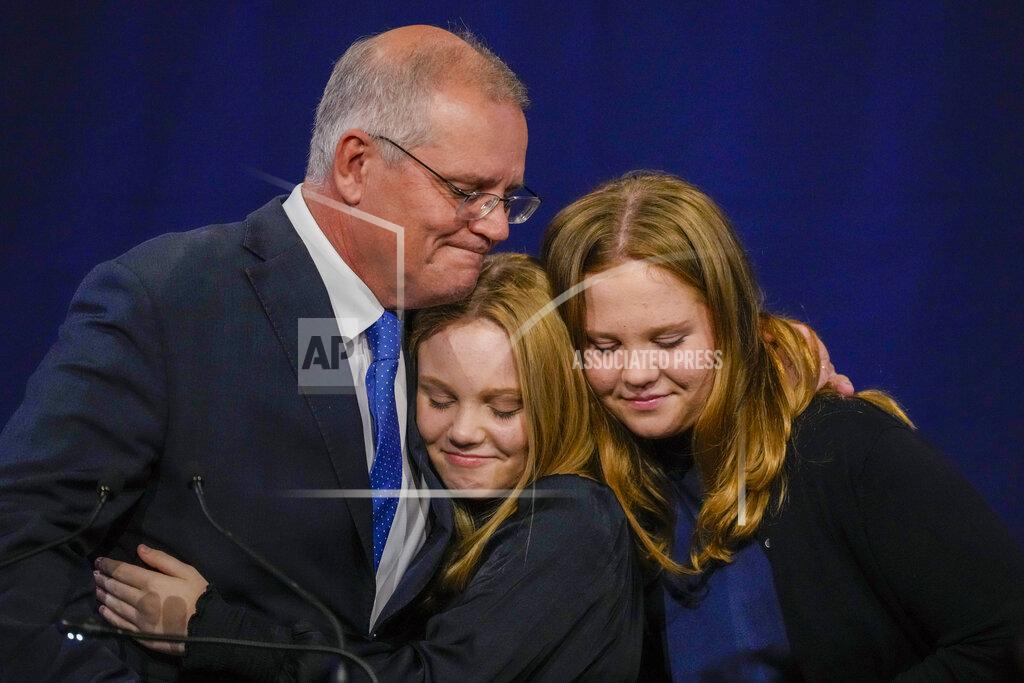 Mark Baker Australian Prime Minister Scott Morrison hugs his daughters Lily and Abbey at a Liberal Party function in Sydney, Australia, Saturday, May 21, 2022. Morrison has conceded defeat and has confirmed that he would hand over the leadership of the Liberal Party following his party's loss to Labor in today's federal election. (AP Photo/Mark Baker)