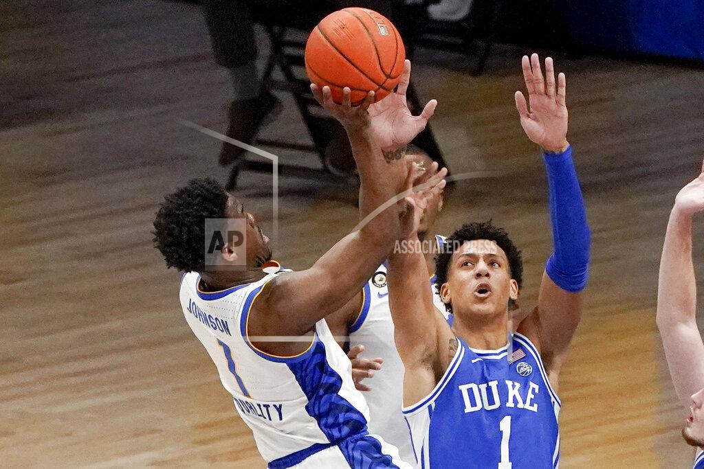 Keith Srakocic Pittsburgh's Xavier Johnson, left, shoots over Duke's Jalen Johnson during the second half of an NCAA college basketball game Tuesday, Jan. 19, 2021, in Pittsburgh. (AP Photo/Keith Srakocic)
