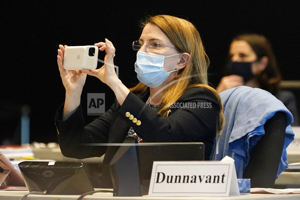 Steve Helber Virginia State Sen. Siobhan Dunnavant, Henrico, takes a photo of the vote on a bill requiring in person learning at state schools during the Senate session at the Science Museum in Richmond, Va., Thursday, Feb. 25, 2021. (AP Photo/Steve Helber)