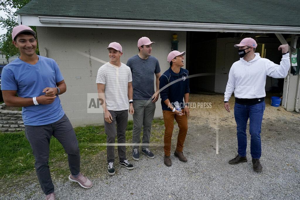 Charlie Riedel Former college teammates from left to right, Dan Giovacchini, Reiley Higgins, Alex Quoyeser, Patrick O'Neill and Eric Armagost, stand outside the barn housing Kentucky Derby entrant Hot Rod Charlie before a workout at Churchill Downs Wednesday, April 28, 2021, in Louisville, Ky. The group owns 25% of the horse being trained by O'Neill's uncle Doug O'Neill. (AP Photo/Charlie Riedel)