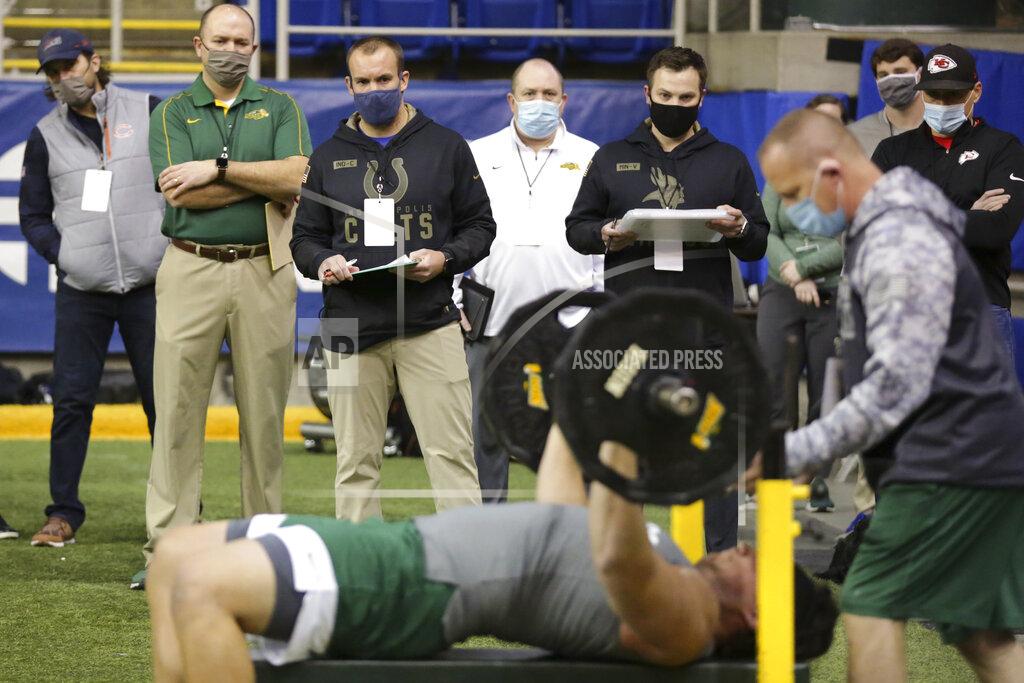 Andy Clayton-King NFL scouts watch North Dakota State lineman Dillon Radunz bench press at the school's football NFL Pro Day Friday, March, 12, 2021, in Fargo, North Dakota. (AP Photo/Andy Clayton- King)