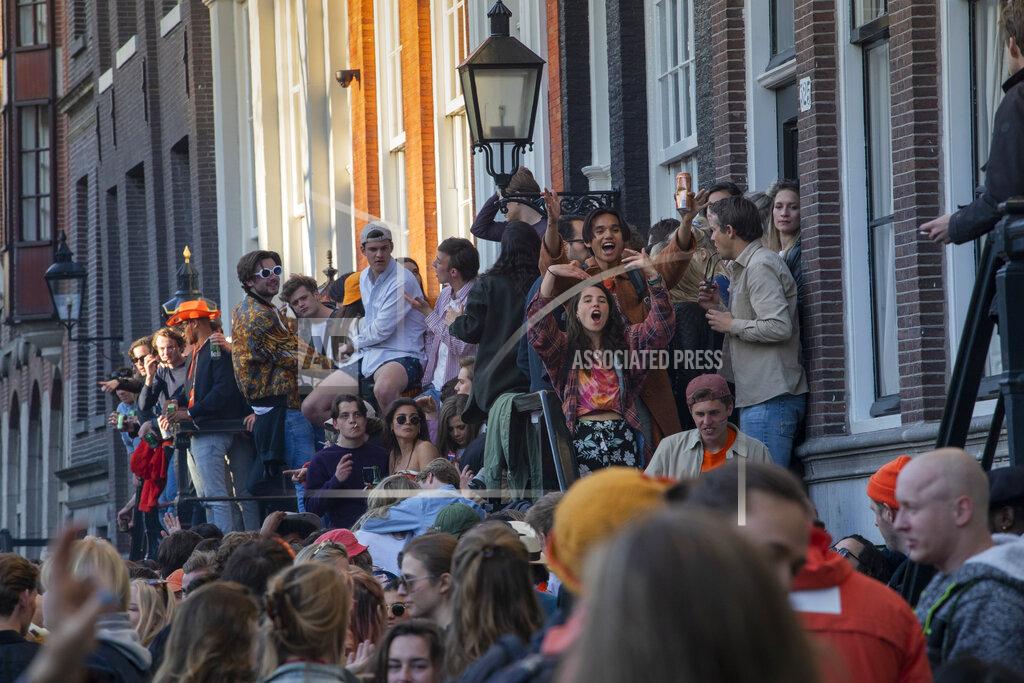 Peter Dejong FILE - In this Tuesday, April 27, 2021 file photo, people gather despite authorities urging people to stick to coronavirus social distancing regulations, as they celebrate King's Day in the center of Amsterdam, Netherlands. Dutch zoos and theme parks will be allowed to re-open next week under strict conditions and bars and cafes can extend the opening hours of their outdoor terraces, if coronavirus infections and hospital admissions continue to fall, caretaker Prime Minister Mark Rutte announced Tuesday, May 11, 2021. (AP Photo/Peter Dejong, file)