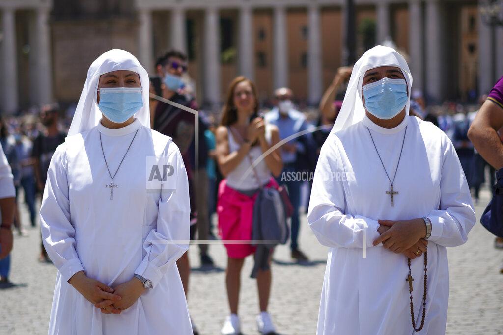 Andrew Medichini Nuns listen as Pope Francis delivers his blessing as he recites the Angelus noon prayer from the window of his studio overlooking St.Peter's Square, at the Vatican, Sunday, June 7, 2020. Pope Francis is cautioning people in countries emerging from lockdown to keep following authorities’ rules for COVID-19 contagion containment. Says Francis: “Be careful, don’t cry victory, don’t cry victory too soon.” (AP Photo/Andrew Medichini)