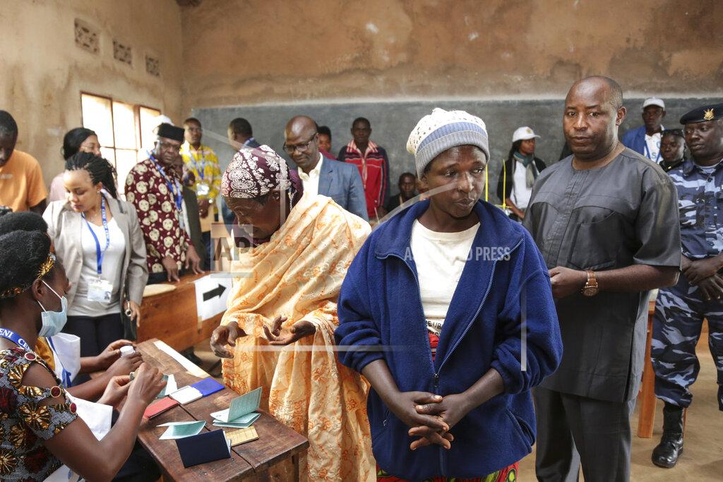Ruling party presidential candidate Evariste Ndayishimiye, right, queues to cast his vote in the presidential election, in Giheta, Gitega province, Burundi Wednesday, May 20, 2020. A crucial election has begun in the East African nation of Burundi, where President Pierre Nkurunziza is stepping aside after a divisive 15-year rule but will remain "paramount leader" in the country that continues to reject outside scrutiny. (AP Photo/Berthier Mugiraneza)