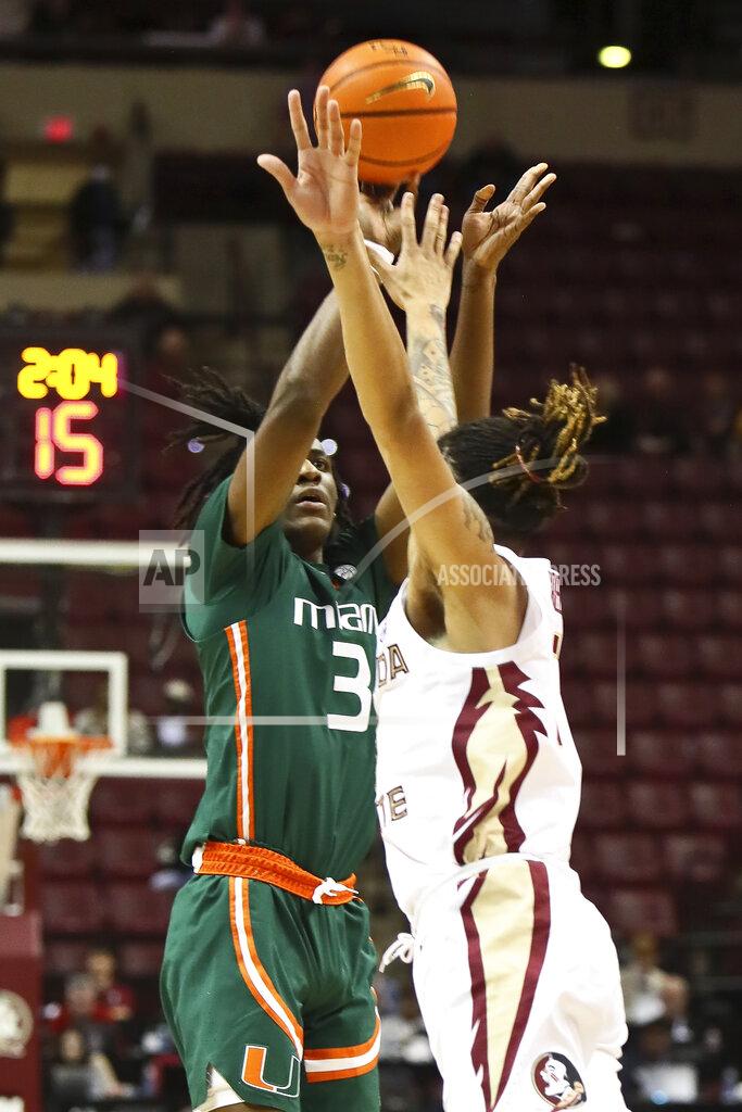 Phil Sears Miami guard Christian Watson (3) shoots a 3-point shot over the defense of Florida State forward De'Ante Green (5) in the second half of an NCAA college basketball game in Tallahassee, Fla., Tuesday, Jan. 24, 2023. (AP Photo/Phil Sears)