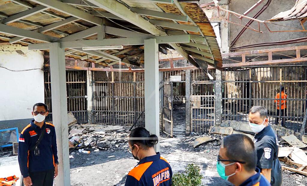 Indonesian Ministry Of Justice In this photo released by the Indonesian Ministry of Justice and Human Rights, police officers inspect damage cells after a fire at Tangerang Prison in Tangerang, Indonesia, Wednesday, Sept. 8, 2021. A massive fire raged through the overcrowded prison near Indonesia's capital early Wednesday, killing a number of inmates. (Indonesian Ministry of Justice and Human Rights via AP)