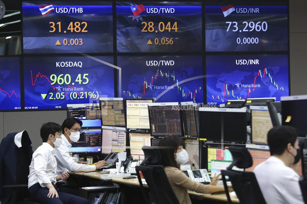 Currency traders watch monitors at the foreign exchange dealing room of the KEB Hana Bank headquarters in Seoul, South Korea, Tuesday, May 18, 2021. Asian shares rose Tuesday, partly on bargain-hunting from the recent global market falls amid continuing pessimism about the coronavirus pandemic. (AP Photo/Ahn Young-joon)