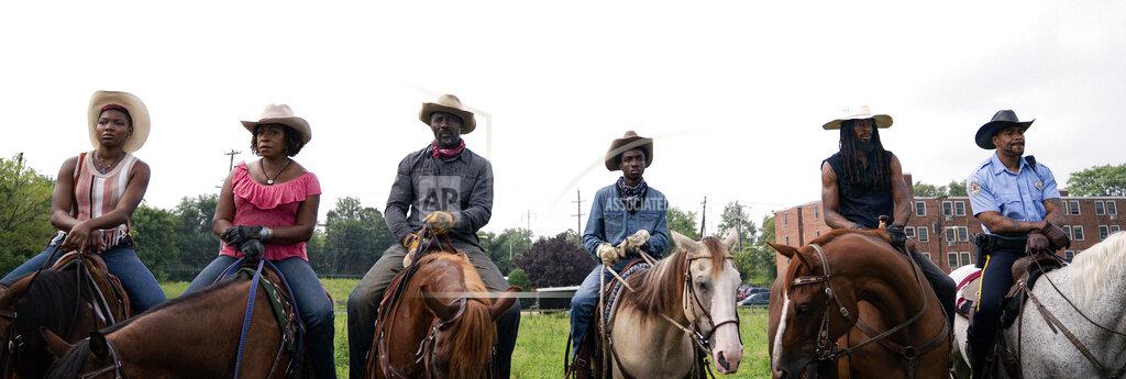 Jessica Kourkounis This image released by Netflix shows, from left, Ivannah-Mercedes, Lorraine Toussaint, Idris Elba, Caleb McLaughlin, Jamil "Mil" Prattis and Cliff "Method Man" Smith in a scene from "Concrete Cowboys." (Jessica Kourkounis/Netflix via AP)