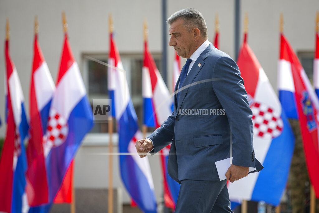 Darko Bandic Croatian Gen. Ret. Ante Gotovina walks past Croatian flags during a ceremony in Knin, Croatia, Wednesday, Aug. 5, 2020. Croatia marked the 25th anniversary of a victorious wartime military offensive, with an ethnic Serb politician attending the ceremony for the first time in what is seen as an important step toward reconciliation. (AP Photo/Darko Bandic)