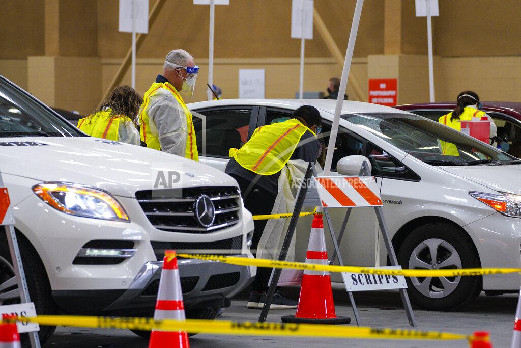 Nelvin C. Cepeda Vaccines are distributed to patients at the new drive-thru site at the Del Mar Fairgrounds on Friday, Feb. 12, 2021 in Del Mar, Calif. (Nelvin C. Cepeda/The San Diego Union-Tribune via AP, Pool)