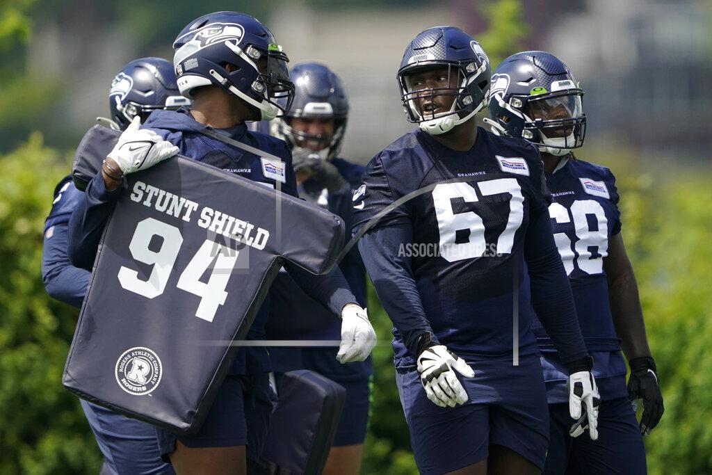 Ted S. Warren Seattle Seahawks tackle Charles Cross (67) talks with teammates during NFL football practice Monday, May 23, 2022, in Renton, Wash. (AP Photo/Ted S. Warren)