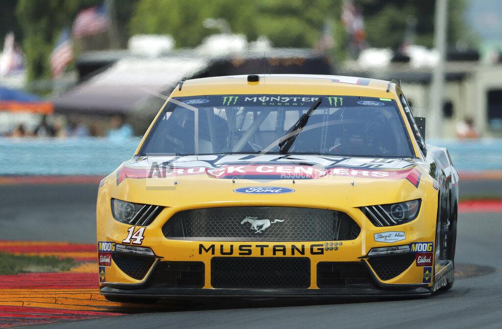 John Munson Clint Bowyer (14) heads through the area known as "The Bus Stop" during a practice run for a NASCAR Cup Series auto race at Watkins Glen International, Saturday, Aug. 3, 2019, in Watkins Glen, N.Y. (AP Photo/John Munson)