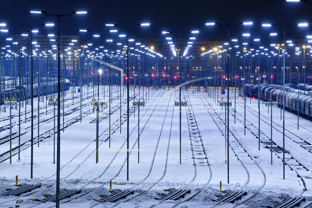 Hendrik Schmidt Snow covers the tracks at a freight station of the railway in Halle/Saale, Germany, Friday, Feb. 12, 2021. The winter weather with snow and sub-zero temperatures expected for Germany on the upcoming weekend. (Hendrik Schmidt/dpa via AP)