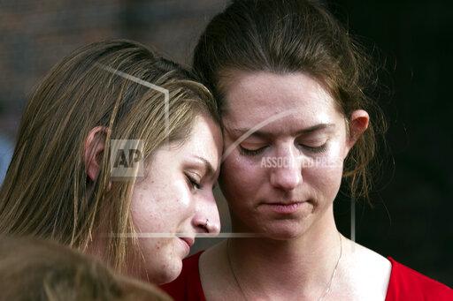 Summerleigh Winters Geimer, left, and her sister Montana Winters Geimer, daughters of Wendi Winters, a community beat reporter who died in the Capital Gazette newsroom shooting, react during a press conference following the sentencing verdict of Jarrod W. Ramos, Tuesday, Sept. 28, 2021, in Annapolis, Md. Ramos was sentenced on Tuesday to more than five life terms without the possibility of parole, according to prosecutors. (AP Photo/Jose Luis Magana)