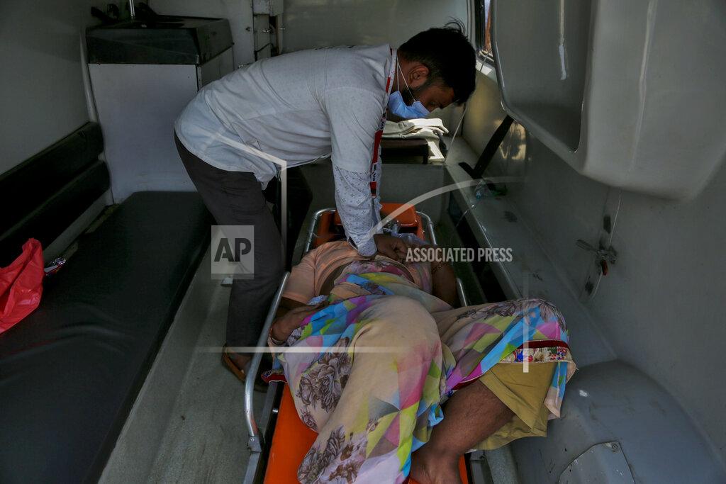 Ajit Solanki A health worker gives cardiopulmonary resuscitation (CPR) to a COVID-19 patient waiting to be attended to inside an ambulance outside a government COVID-19 hospital in Ahmedabad, India, Tuesday, April 27, 2021. The COVID-19 death toll in India has topped 200,000 as the country endures its darkest chapter of the pandemic yet. (AP Photo/Ajit Solanki)