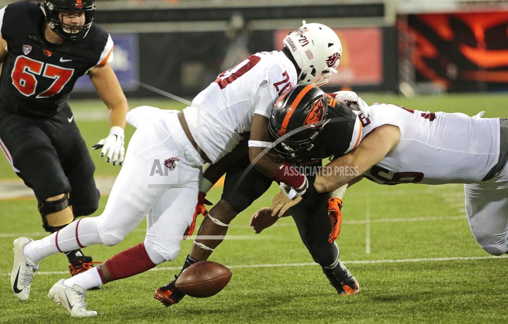 Timothy J. Gonzalez Oregon State's Jermar Jefferson, center, fumbles the ball near the end zone after taking a hit from Washington State's Dominick Sivlels (20) and Taylor Comfort, right, during the fourth quarter of an NCAA college football in Corvallis, Ore., Saturday, Oct. 6, 2018. (AP Photo/Timothy J. Gonzalez)