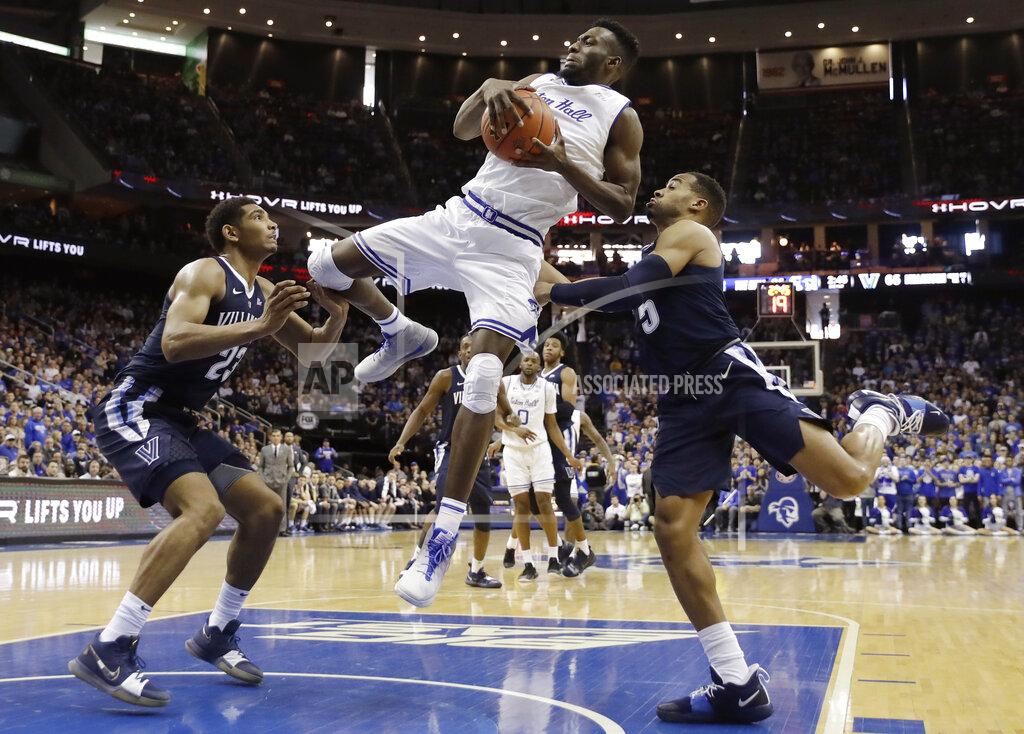 Kathy Willens Seton Hall forward Michael Nzei (1) pulls down a rebound as Villanova forward Jermaine Samuels (23) and Villanova guard Phil Booth (5) defend him during the second half of an NCAA college basketball game, Saturday, March 9, 2019, in Newark, N.J. Seton Hall defeated Villanova 79-75. (AP Photo/Kathy Willens)