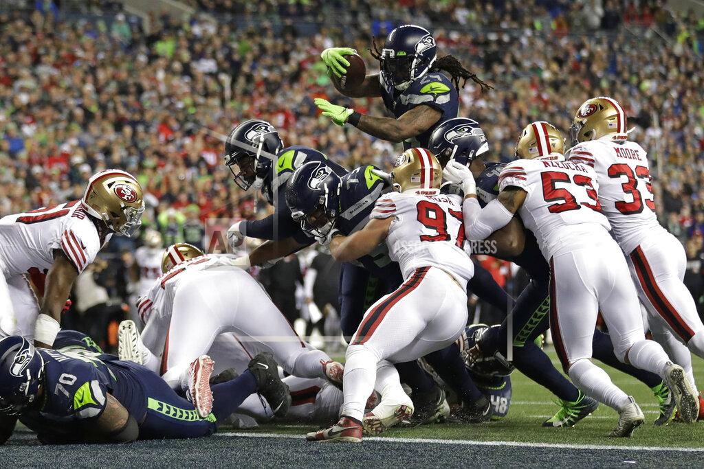Ted S. Warren Seattle Seahawks running back Marshawn Lynch, top, leaps to score a touchdown against the San Francisco 49ers during the second half of an NFL football game, Sunday, Dec. 29, 2019, in Seattle. The 49ers won 26-21. (AP Photo/Ted S. Warren)