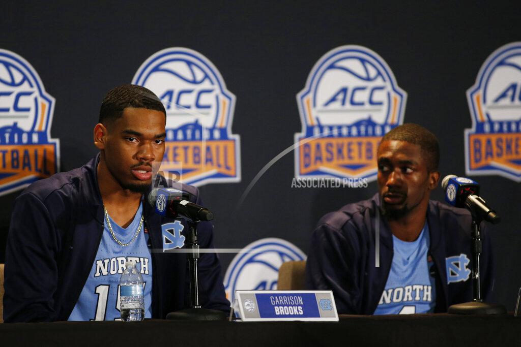 Nell Redmond North Carolina player Garrison Brooks, left, answers a question as teammate Brandon Robinson looks on during the Atlantic Coast Conference NCAA college basketball media day in Charlotte, N.C., Tuesday, Oct. 8, 2019. (AP Photo/Nell Redmond)