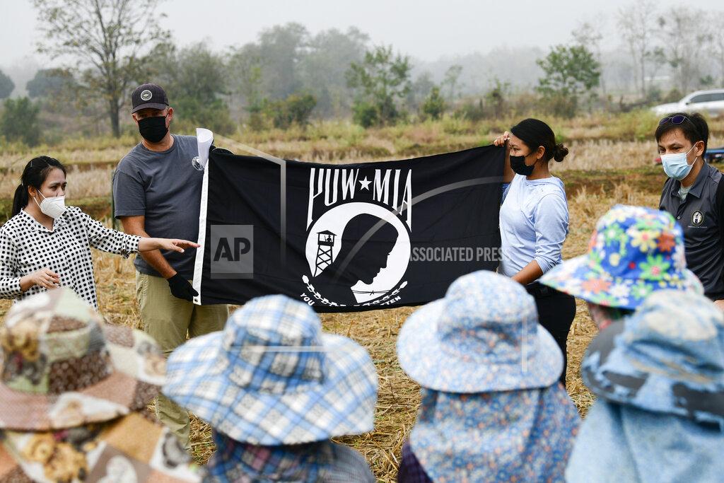 Michael O'NEal Personnel assigned to the Defense POW/MIA Accounting Agency (DPAA), talk about The National League of Families POW/MIA flag to local Thai workers during excavation operations in Lampang Province, Thailand, Feb. 16, 2022. Possible human remains were found at a crash site in a rice field in northern Thailand by the Defense POW/MIA Accounting Agency and were sent to Hawaii where they will be tested to see if they belong to a U.S. pilot who went missing in 1944. (U.S. Army Sgt. 1st Class Michael O'Neal/Defense POW/MIA Accounting Agency via AP)
