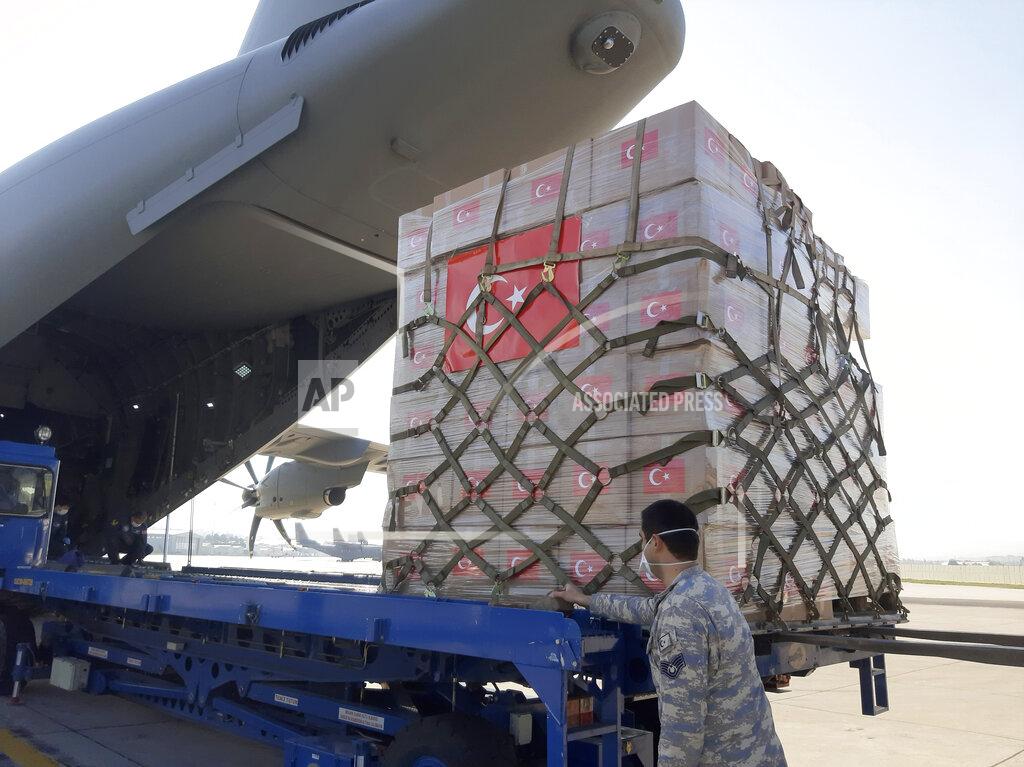 Uncredited In this handout photo provided by the Turkish Defense Ministry, Turkish soldiers prepare to load a military cargo plane with Personal Protection Equipment donated by Turkey to help United States combat the new coronavirus outbreak, at the Etimesgut airport outside Ankara, Turkey, Tuesday, April 28, 2020. Turkey is sending a planeload of surgical masks, N95 masks and hazmat suits to U.S. to help the country battle the coronavirus outbreak.(Turkish Defence Ministry via AP)