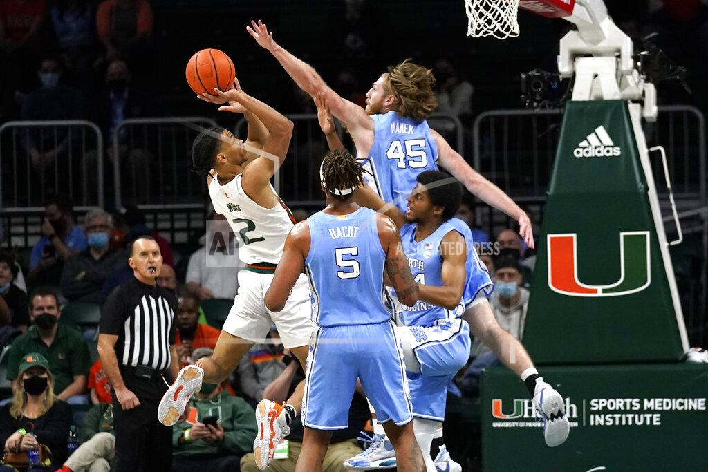 Lynne Sladky Miami guard Isaiah Wong (2) shoots as North Carolina forward Brady Manek (45) defends during the first half of an NCAA college basketball game, Tuesday, Jan. 18, 2022, in Coral Gables, Fla. (AP Photo/Lynne Sladky)