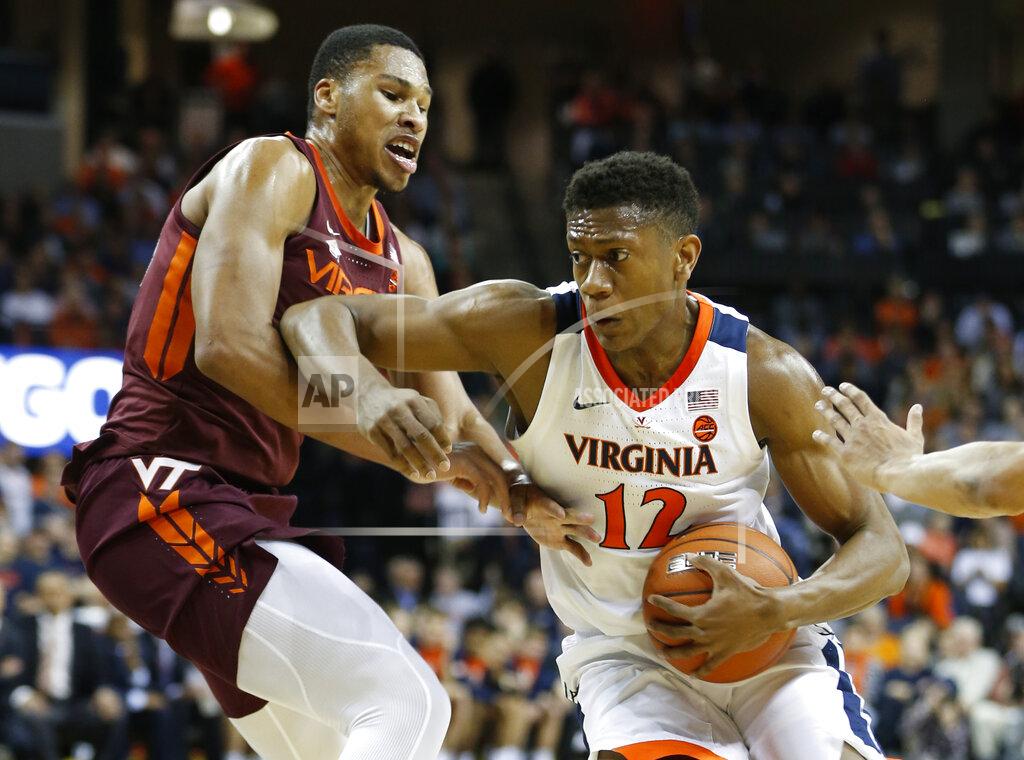 Steve Helber Virginia Tech forward Kerry Blackshear Jr. , left, tries to block Virginia guard De'Andre Hunter (12) during the first half of an NCAA college basketball game in Charlottesville, Va., Tuesday, Jan. 15, 2019. (AP Photo/Steve Helber)