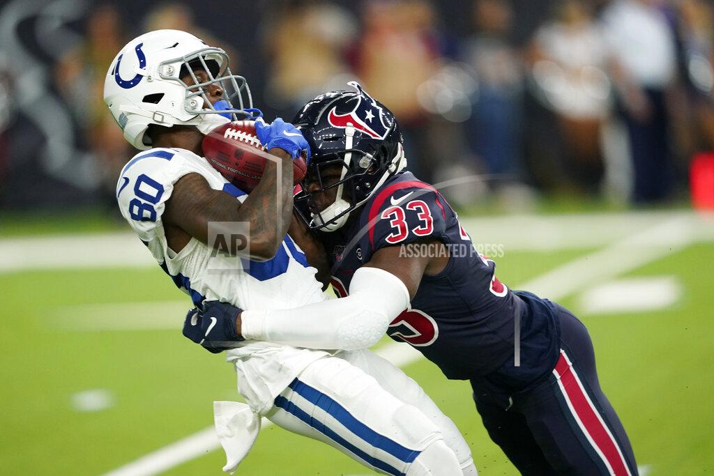 David J. Phillip Indianapolis Colts wide receiver Chester Rogers (80) is hit by Houston Texans defensive back A.J. Moore (33) on a punt return during the first half of an NFL football game Thursday, Nov. 21, 2019, in Houston. (AP Photo/David J. Phillip)