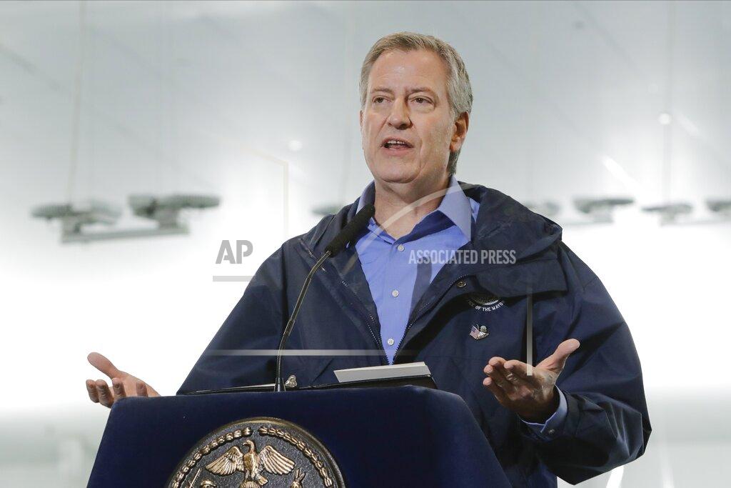 Frank Franklin Ii FILE - In this March 31, 2020 file photo, New York City Mayor Bill de Blasio speaks at the USTA Indoor Training Center where a 350-bed temporary hospital will be built in New York. De Blasio is calling for a national enlistment program for doctors and nurses, on Friday, April 3, to handle an expected surge in coronavirus cases in New York and other places around the country. (AP Photo/Frank Franklin II, File)