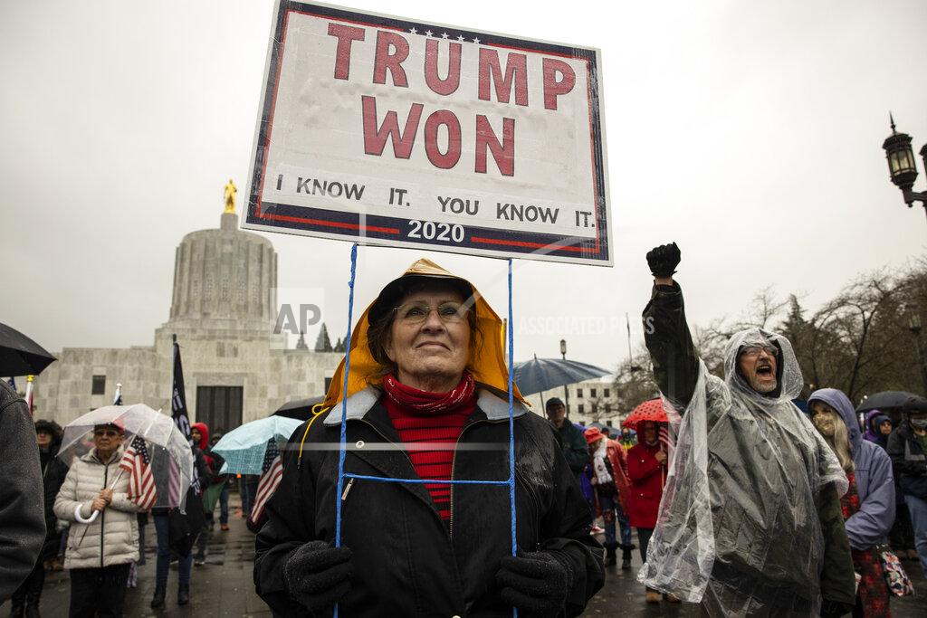 Paula Bronstein FILE - In this Jan. 6, 2021 file photo, a supporter of President Donald Trump gathers to protest in solidarity in Salem, Ore. Statehouses where Trump loyalists have rallied since the Nov. 3 election are heightening security after the storming of the U.S. Capitol this week. Police agencies in a number of states are monitoring threats of violence as legislatures return to session and as the nation prepares for the inauguration of President-elect Joe Biden. (AP Photo/Paula Bronstein, File)