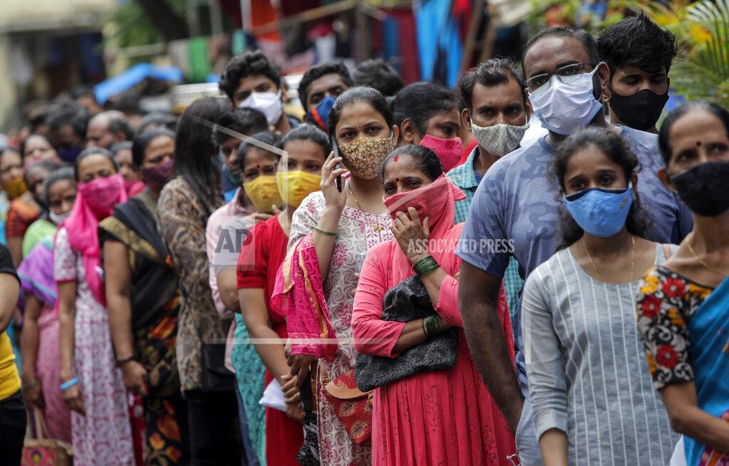 Rajanish Kakade People line up to get inoculated against the coronavirus at a vaccination camp organized by the Reliance Foundation and Municipal Corporation of Greater Mumbai in Mumbai, India, Monday, Aug. 2, 2021. (AP Photo/Rajanish Kakade)
